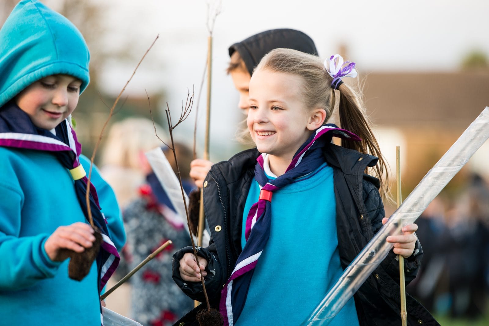 Beaver Scouts holding tree saplings at a local group activity