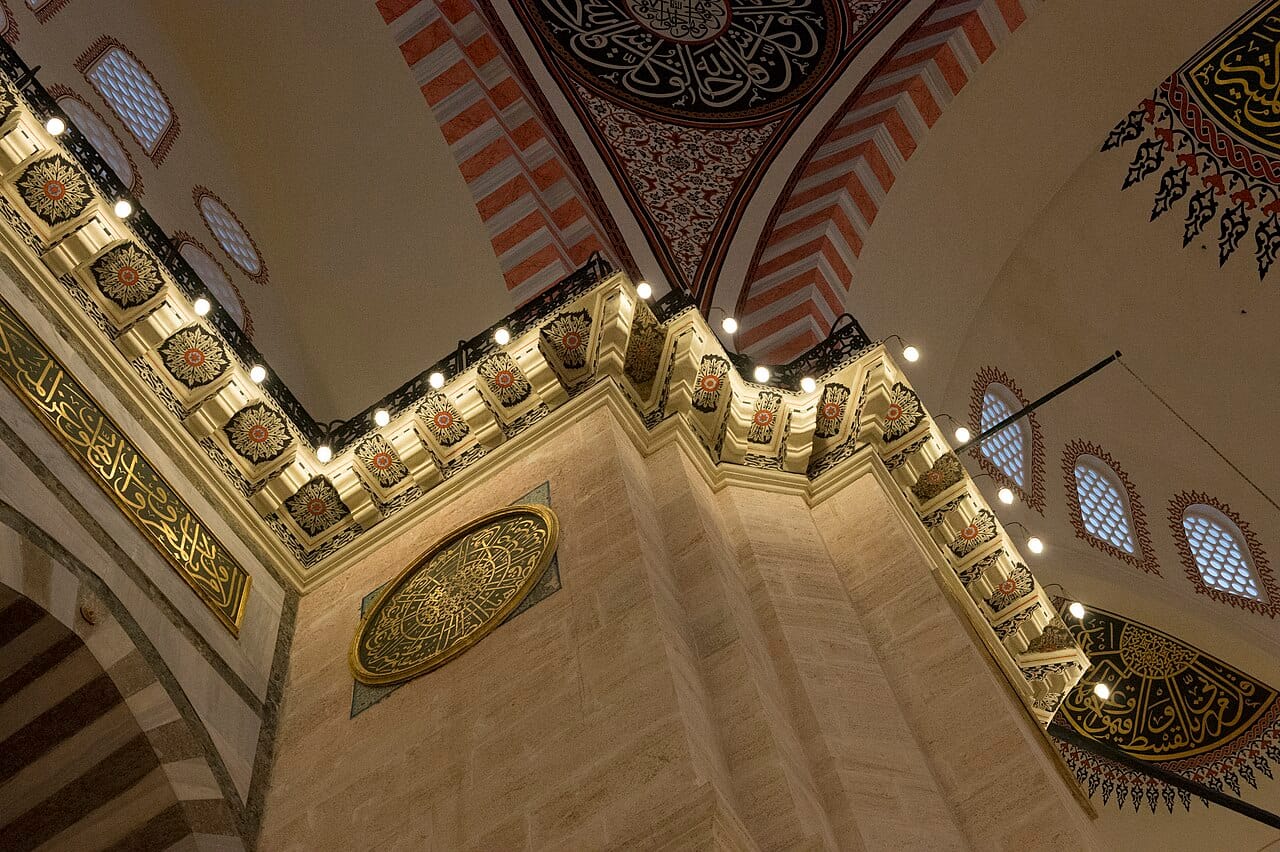 Mosque interior with arches and decorated ceiling
